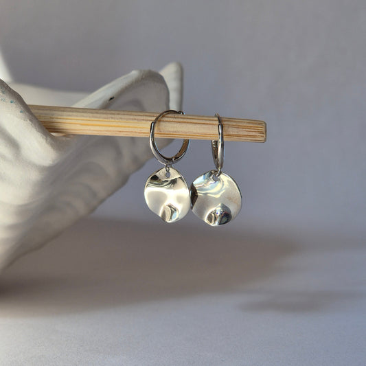 Two Sterling Silver earrings with plain background