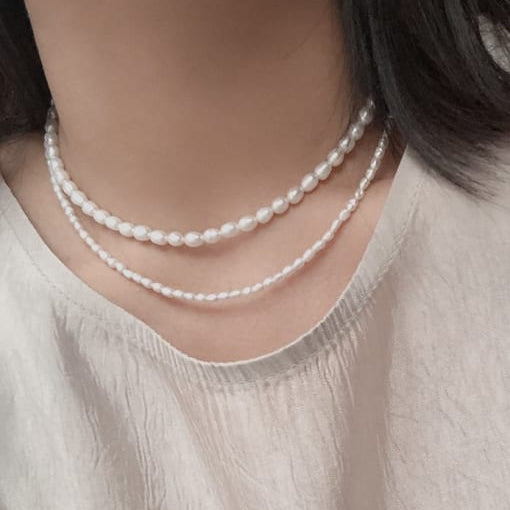 woman wearing two strands of freshwater pearls