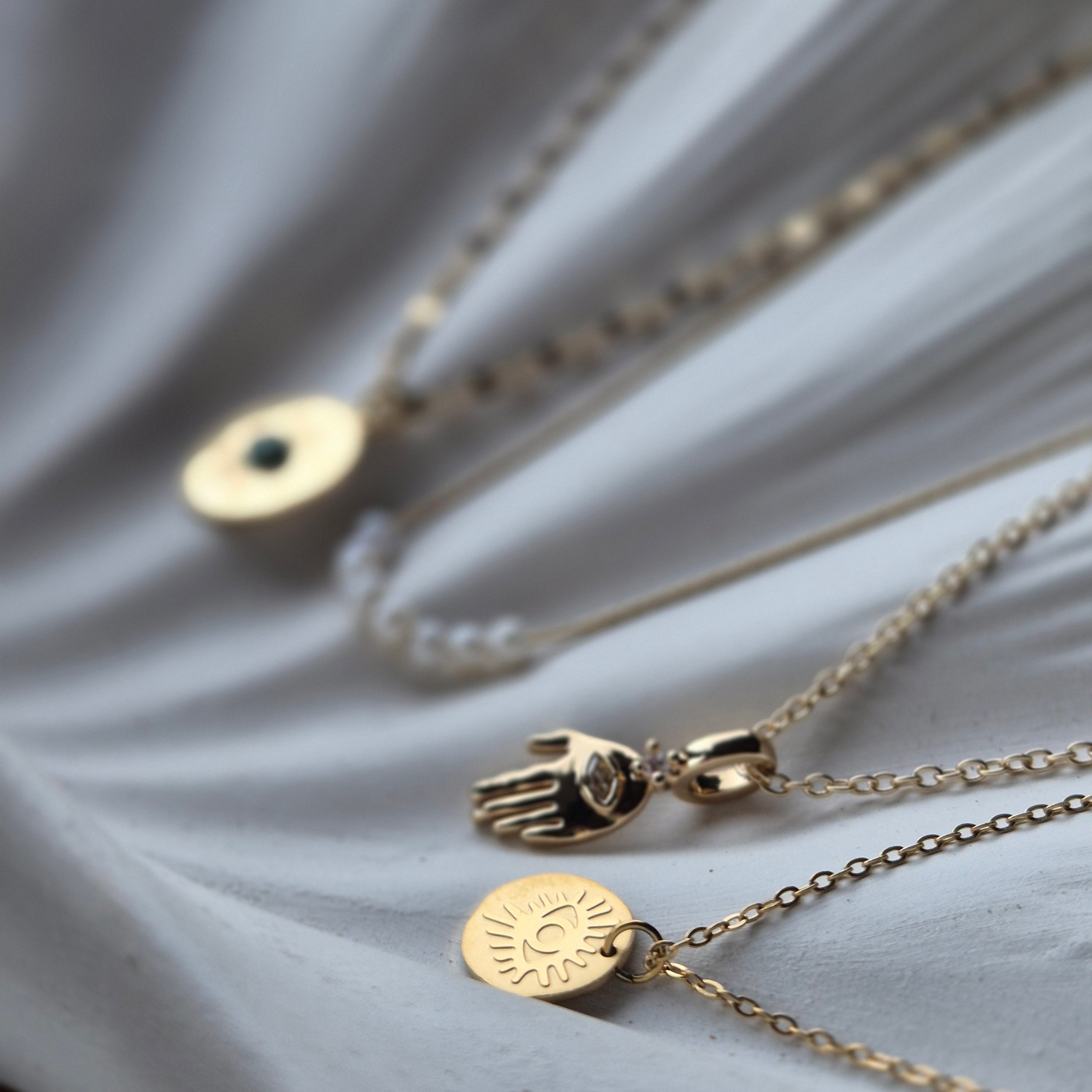 Selection of gold necklaces from Sorella of May