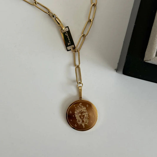 namaste medusa god paper chain necklace on plain background